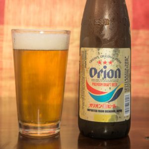 a bottle of Japanese beer and a pint glass