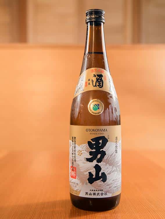 a bottle of Otokoyama Tokubetsu Junmai in a kappo style restaurant