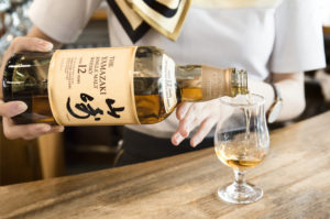 Suntory whisky skillfully poured into a glass