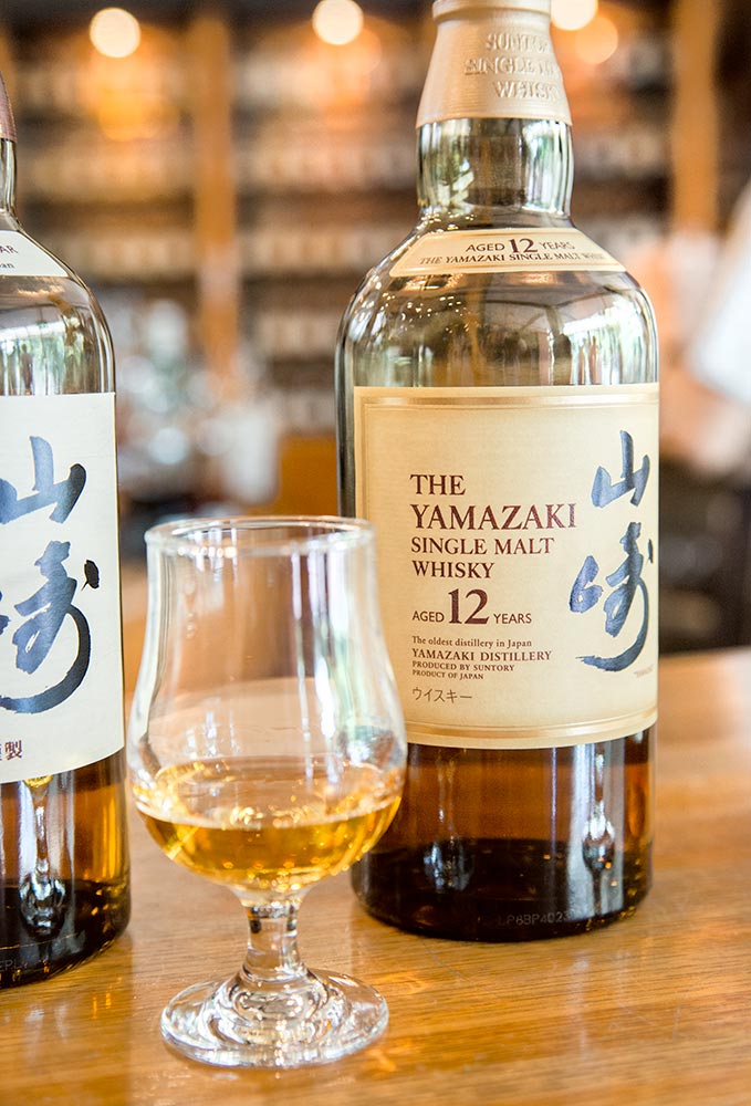 A bottle and tasting glass of Yamazaki 12 Year whiskey