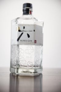 a bottle of Japanese gin on a wooden table