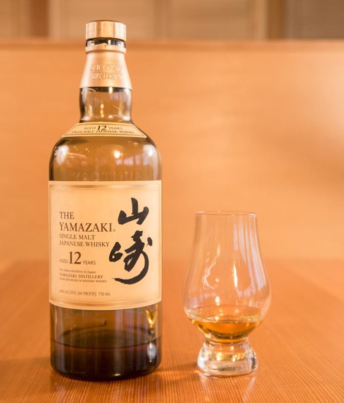 A bottle of Suntory Yamazaki 12 Whiskey and a tasting glass.