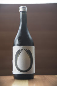 bottle of Nanbu Bijin Shinpaku on a wooden table