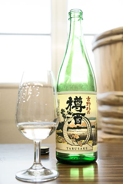 A bottle and glass full of Choryo Toshinosugi Taru Sake