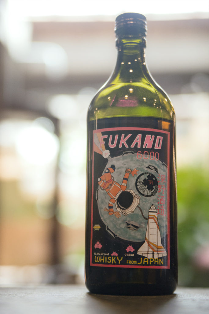 a bottle of Fukano Whisky in a well-lit bar