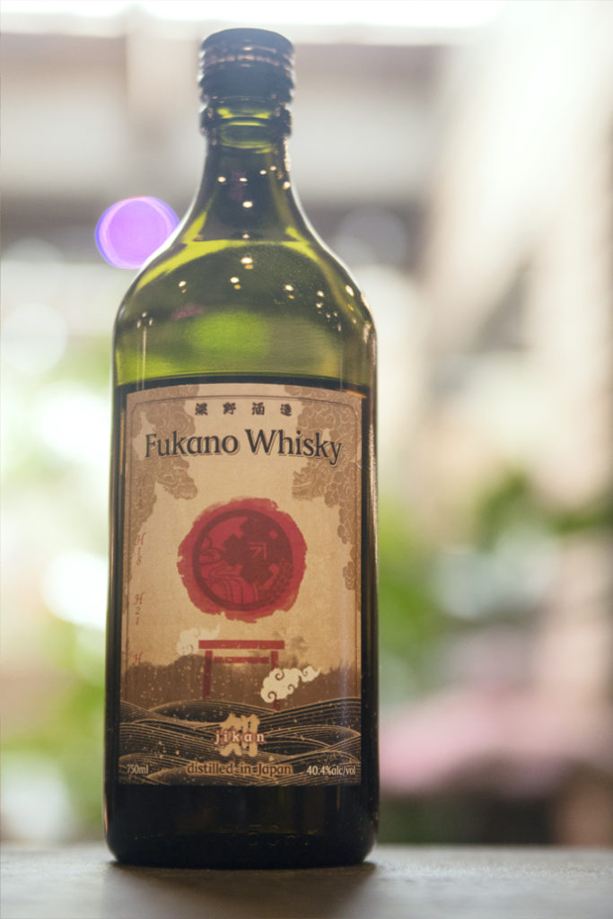 a bottle of Fukano Whisky in a brightly lit bar
