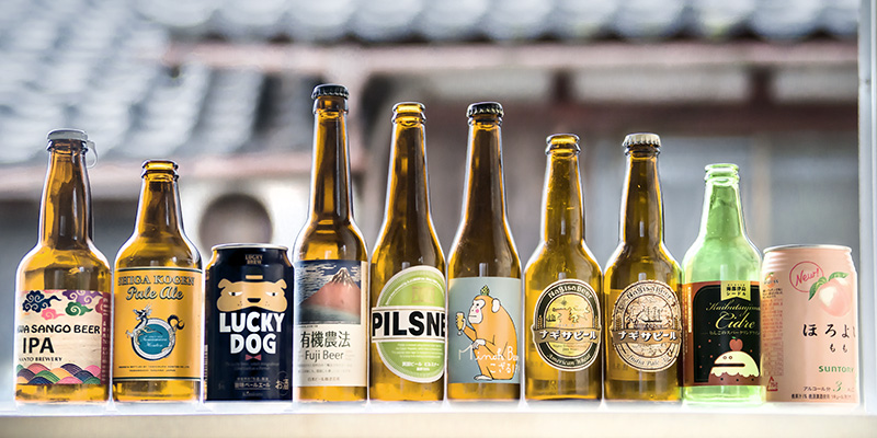 a row with many colorful bottles of Japanese beers