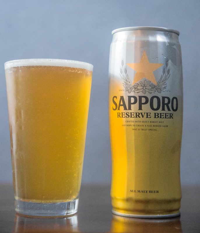 A can of Japanese beer on a full pint glass.
