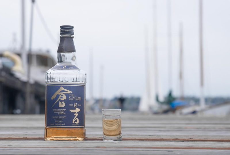 Kurayoshi whiskey on a dock with sailboats