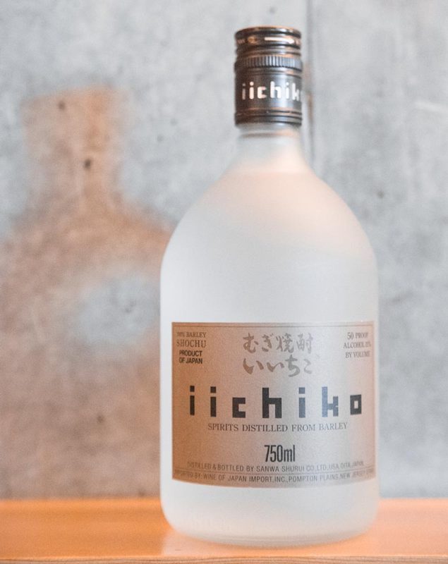 A bottle of Iichiko barley shochu in a Japanese restaurant.