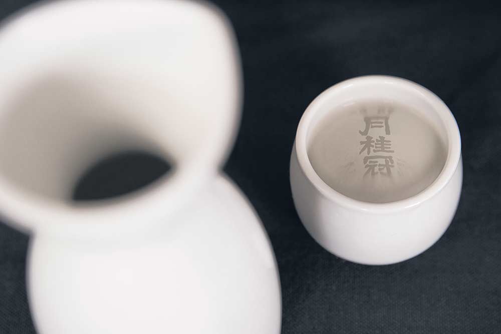 sake cup with a reflection of the Gekkeikan brand
