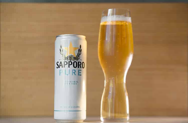 a can of Japanese light beer and a pilsner glass