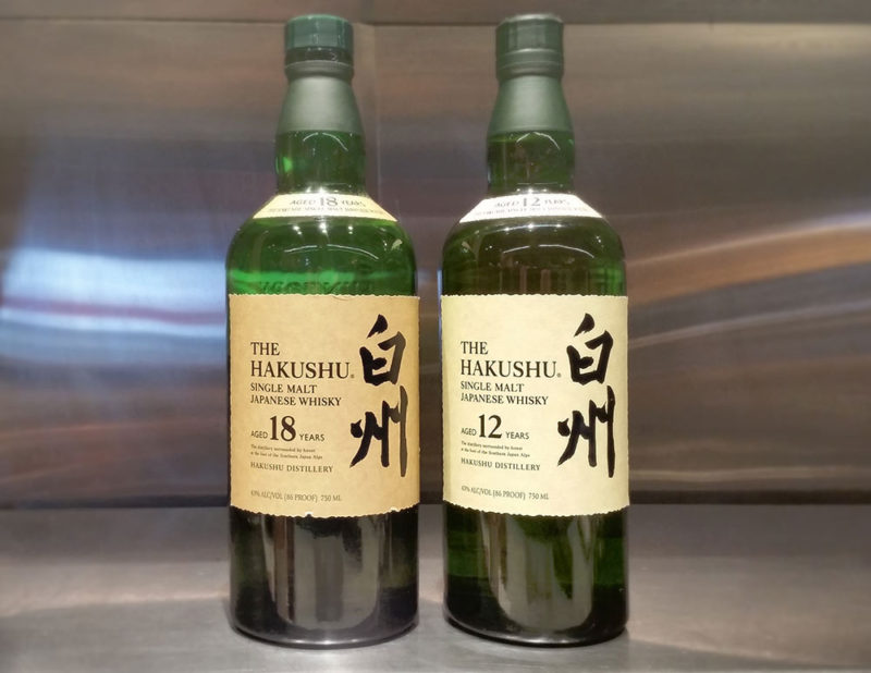 Two green bottles of Hakushu whiskey