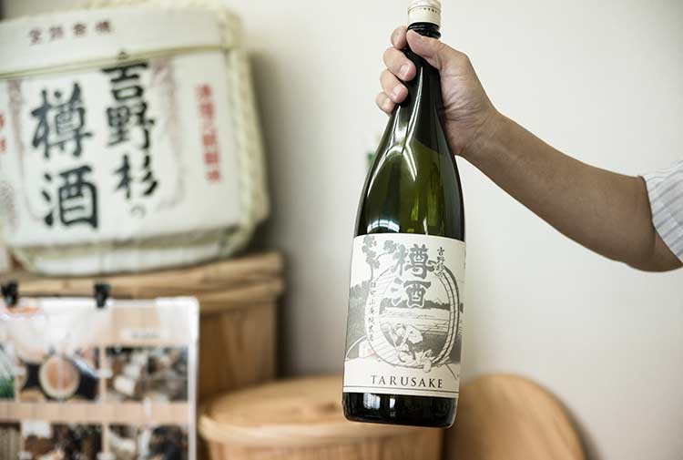 A 1.8 liter bottle of sake with cedar casks in the background