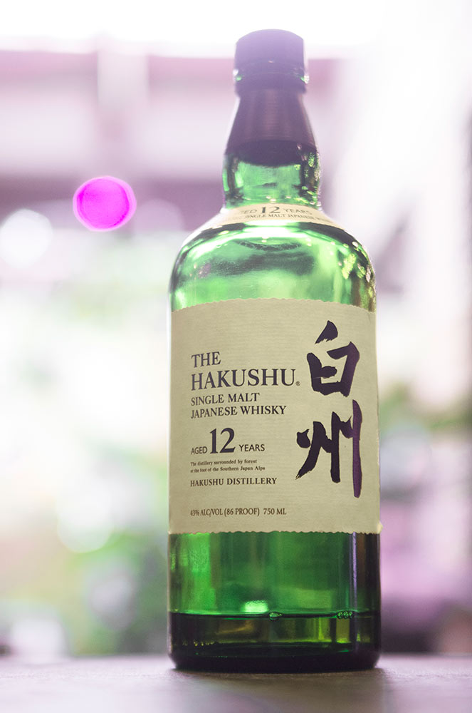 A nearly-empty bottle of Suntory Japanese whisky.