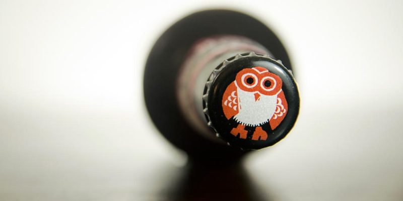 a beer cap with an owl logo