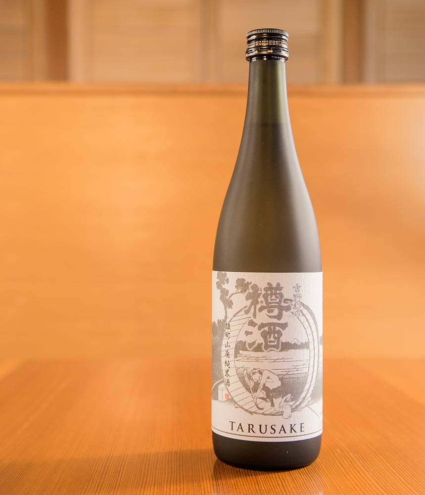 A bottle of taru sake in a wooden room