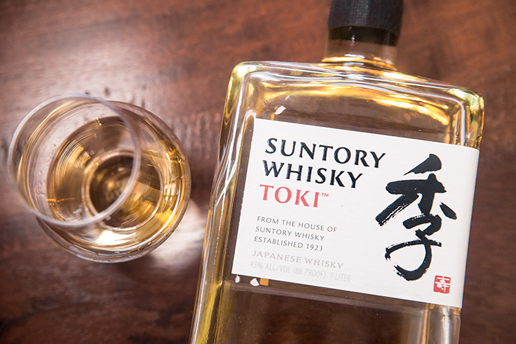 a tasting glass and a bottle of Japanese whisky