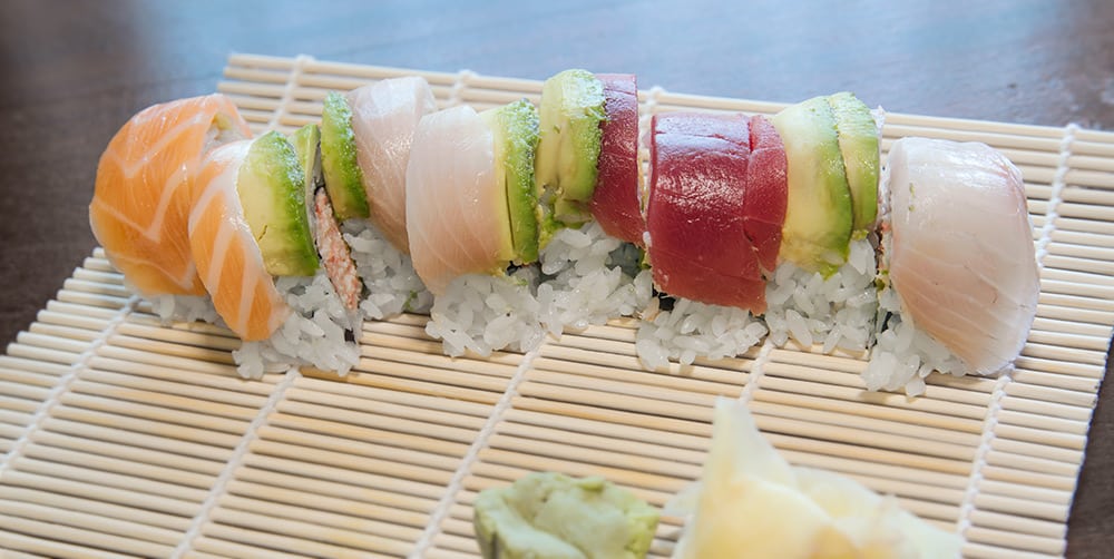 a sushi roll on a makisu
