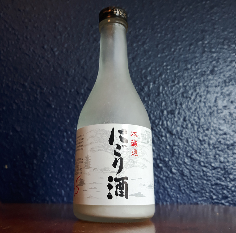 a white bottle of sake with a blue backdrop