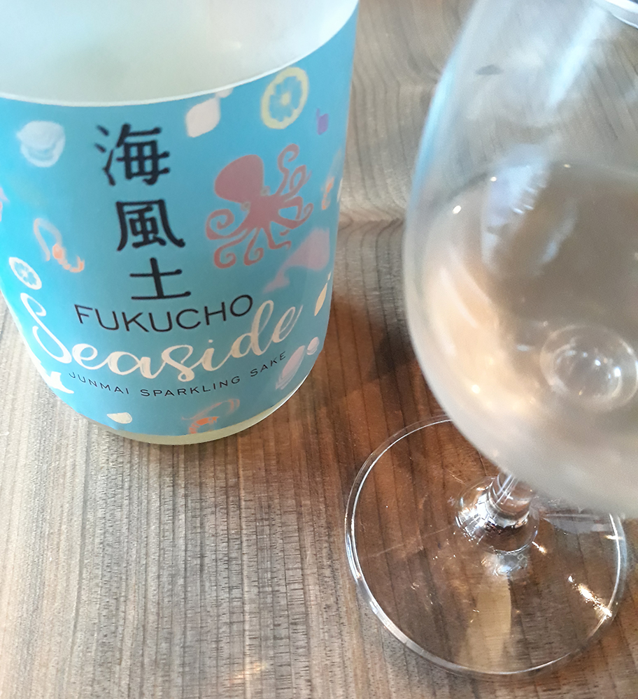 a colorful bottle of sparkling sake
