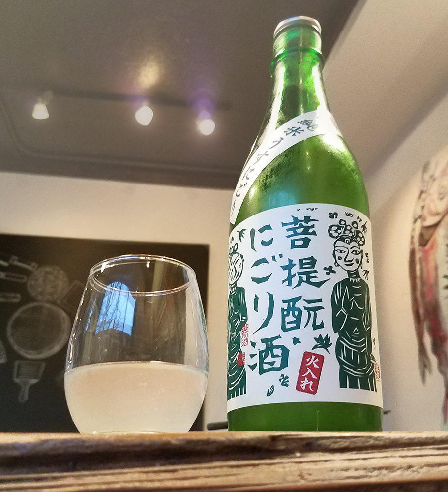 a bottle and glass of nigori sake
