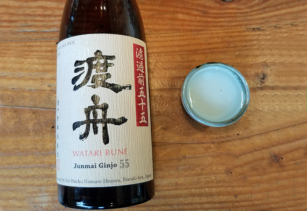 a bottle of junmai ginjo sake and a blue cup