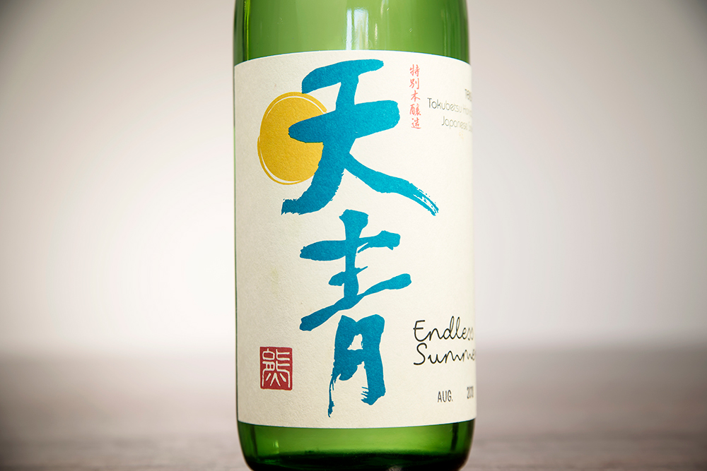 a green and blue label of sake