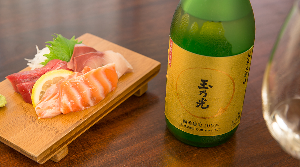 sashimi and Tamanohikari sake bottle
