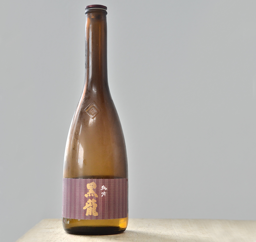 a bottle of Fukui sake on a wooden table