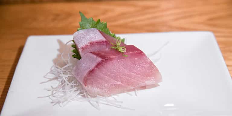 two slices of yellowtail sashimi