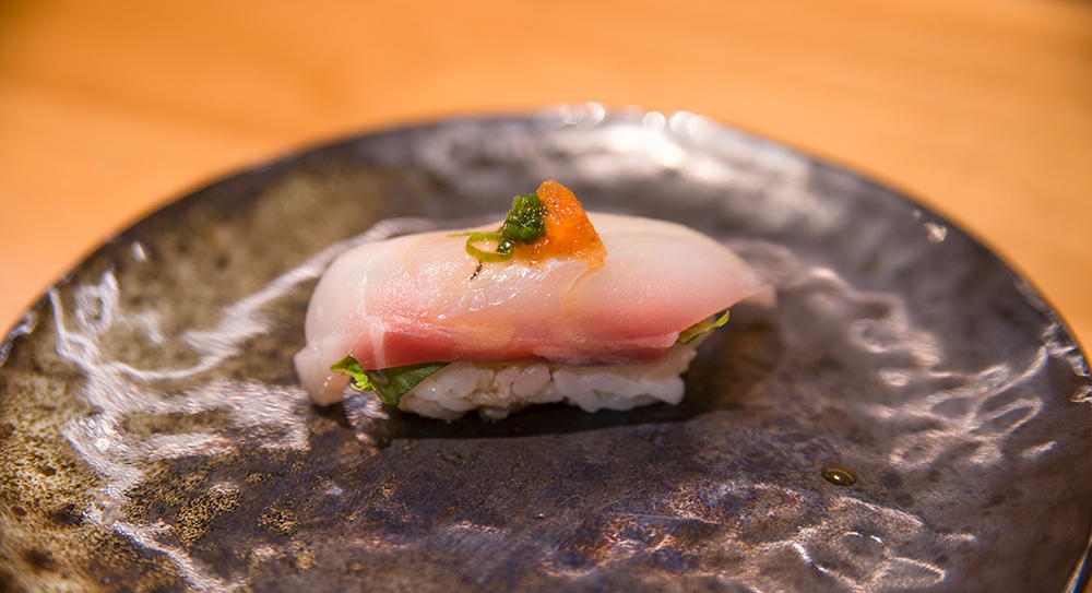 a piece of striped bass nigiri sushi