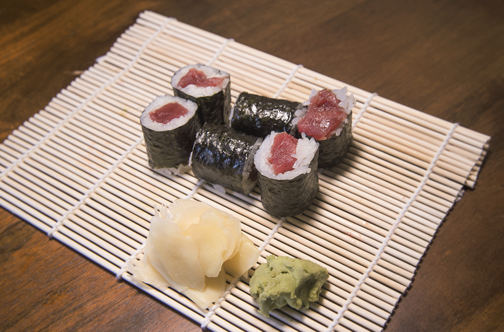 a tuna sushi roll on a bamboo mat