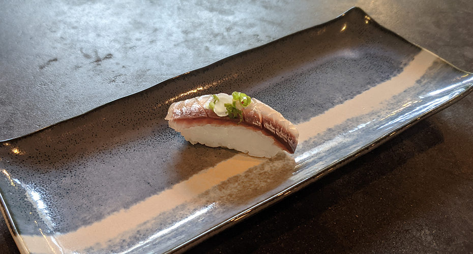 a piece of aji sushi