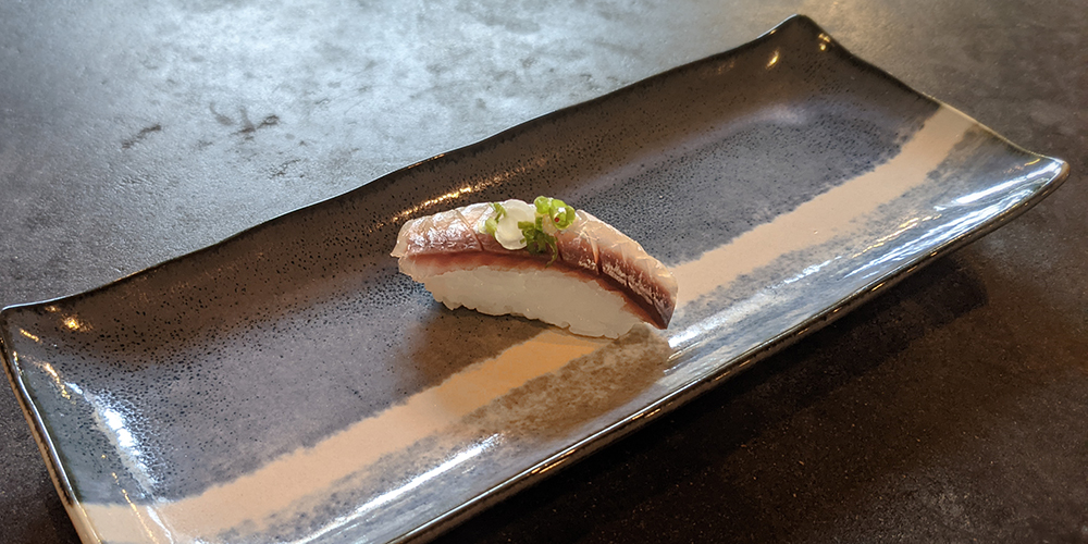 a piece of aji sushi