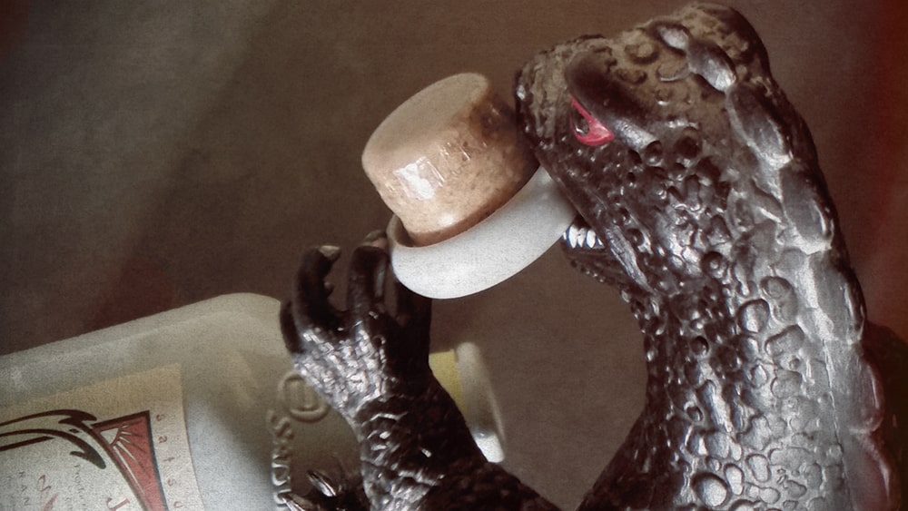 Godzilla attacking a bottle of mugi shochu