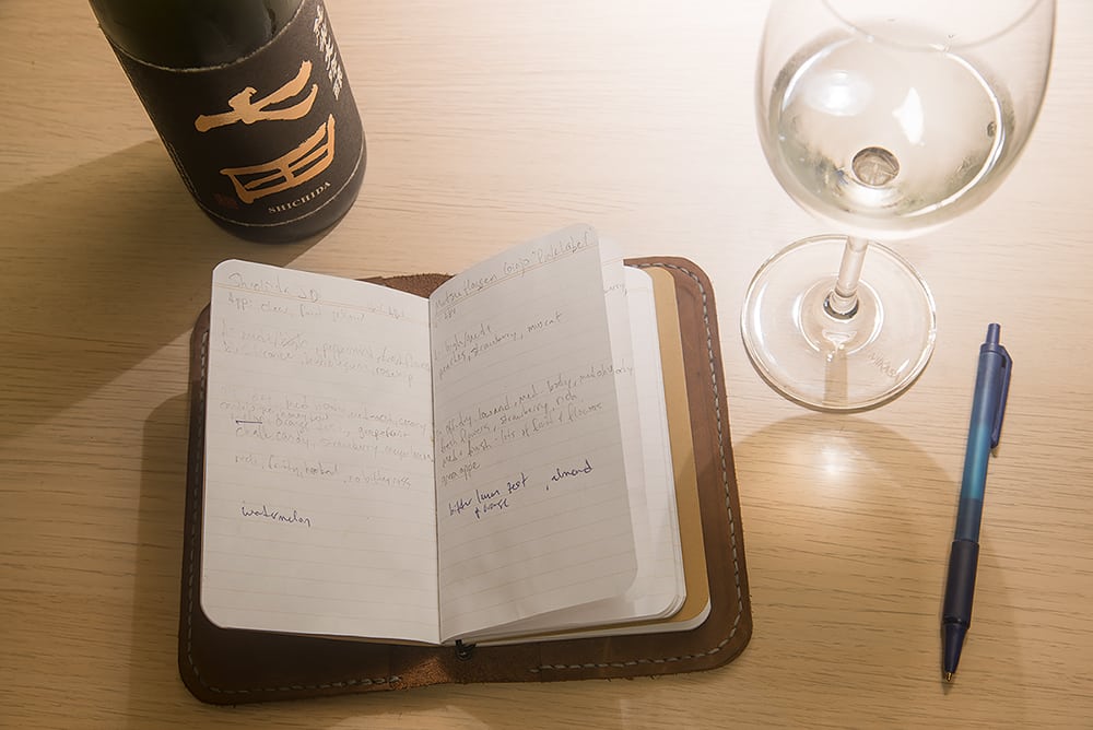 professional sake tasting with a notebook