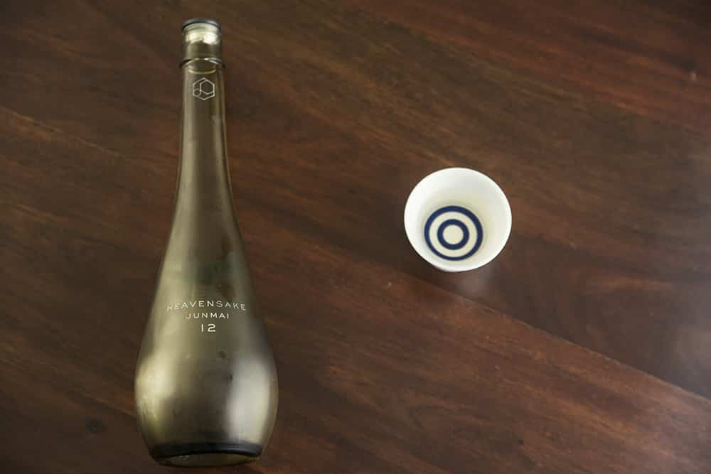 a yellow bottle of nihonshu and a janome cup