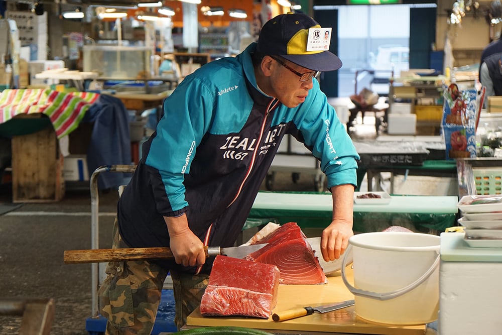 cutting slabs of hon maguro for sushi
