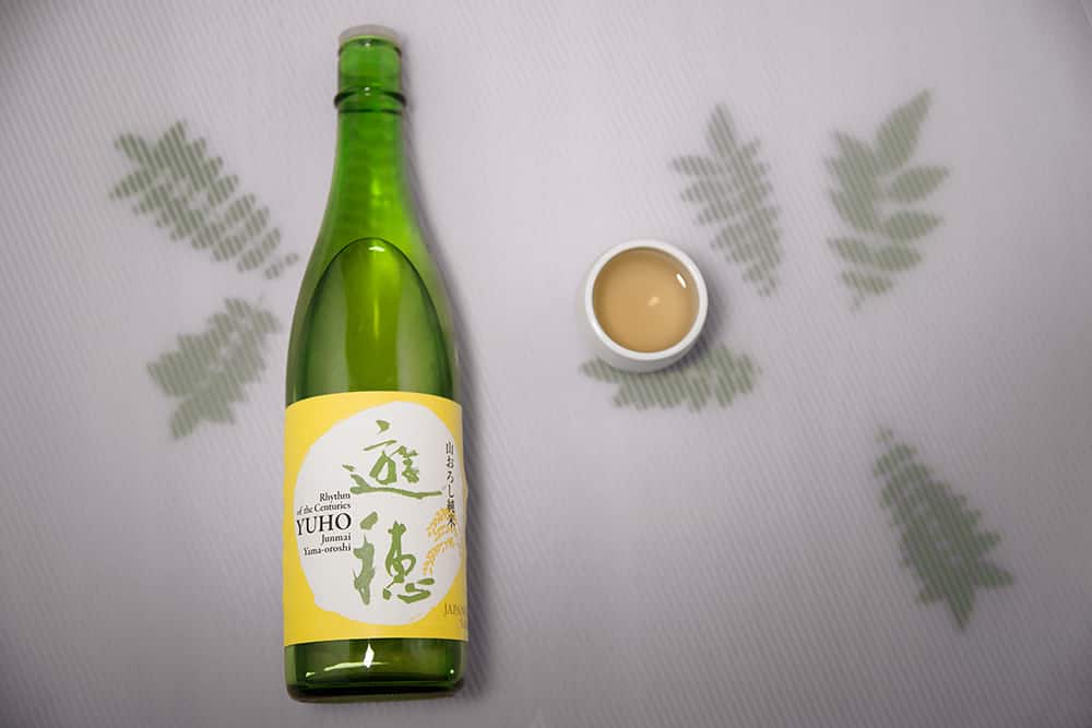 a bottle of Yuho sake and sansho leaves