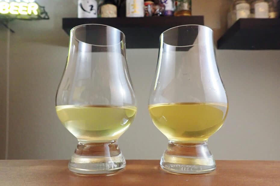 two tasting glasses with greenish-gold alcohol