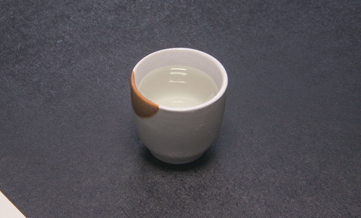 a small white and brown sake cup