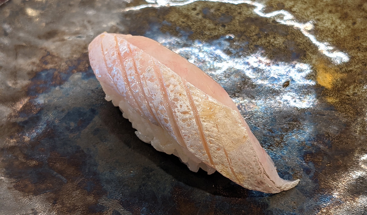 a piece of amberjack belly nigiri sushi