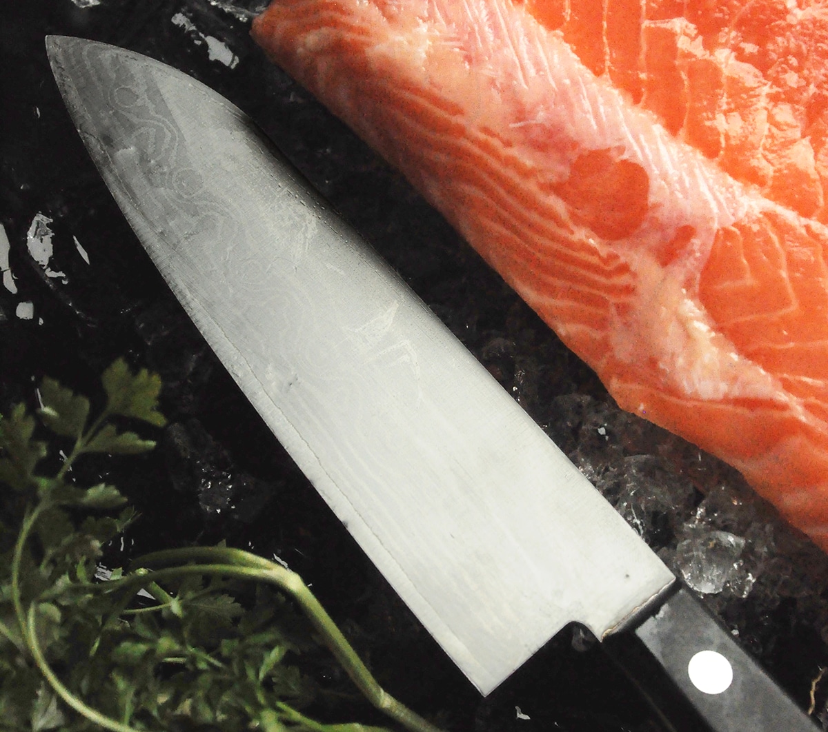 and filet of salmon and a santoku knife